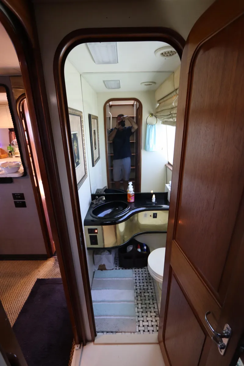 Slide: The Image of 1991 Viking Motor Yacht bathroom with black sink and wooden cabinetry. - 39