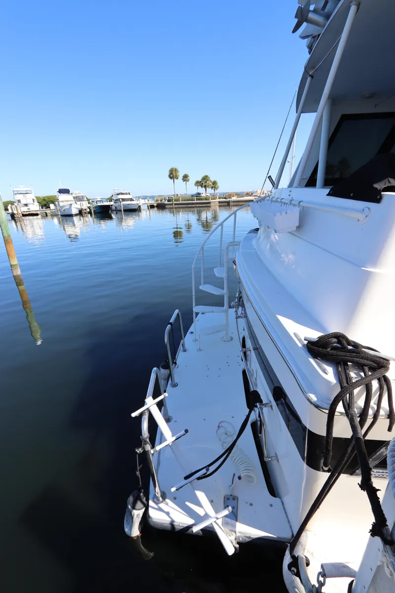 Slide: The Image of 1991 Viking Motor Yacht docked at a marina on a sunny day. - 4