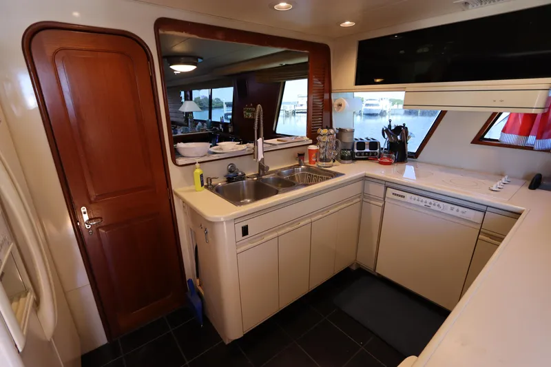 Slide: The Image of 1991 Viking Motor Yacht kitchen with modern appliances and wooden cabinetry. - 42