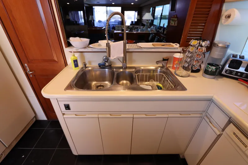 Slide: The Image of Kitchen sink area in a 1991 Viking Motor Yacht with modern fixtures and appliances. - 43