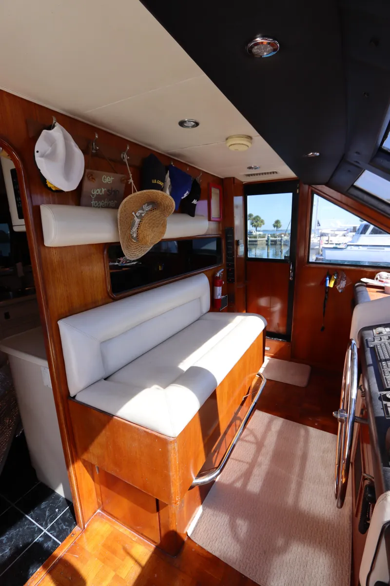 Slide: The Image of Interior of a 1991 Viking Motor Yacht with white seating and wooden finishes. - 48