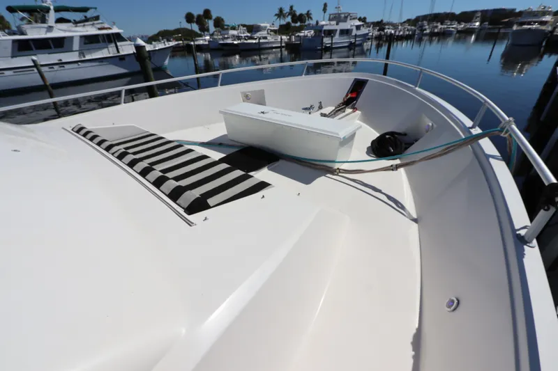 Slide: The Image of 1991 Viking Motor Yacht bow with striped cushions and marina view. - 6