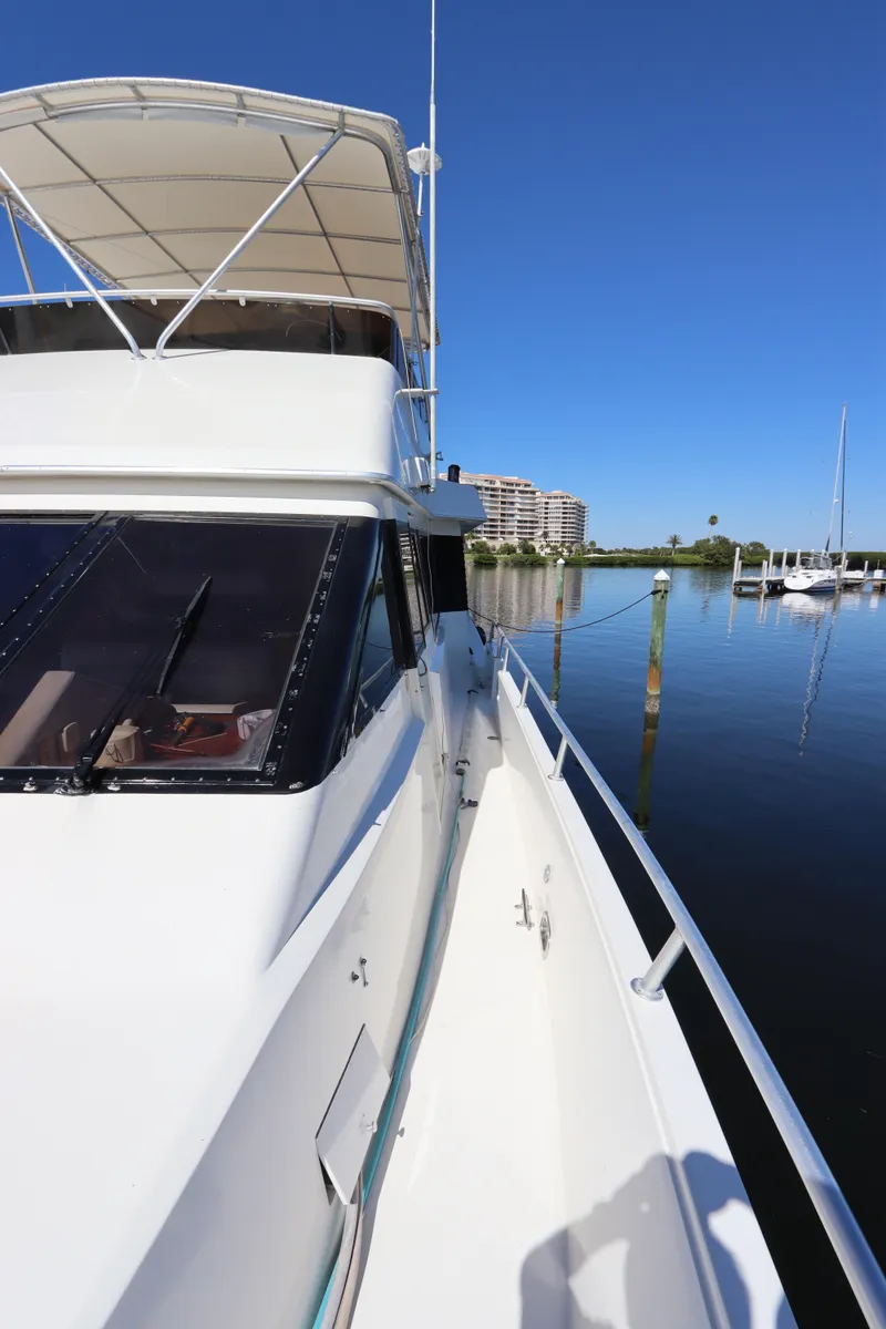 Slide: The Image of 1991 Viking Motor Yacht docked in a serene marina. - 9
