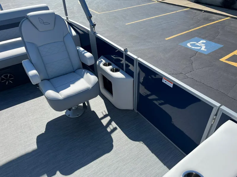 Slide: The Image of 2024 Lowe SS 210 DL boat interior with captain's chair and cup holders. - 12