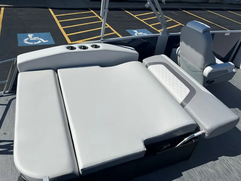 Slide: The Image of 2024 Lowe SS 210 DL boat interior with cushioned seating and cup holders. - 16