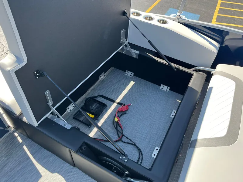 Slide: The Image of 2024 Lowe SS 210 DL boat storage compartment with battery and cables. - 17