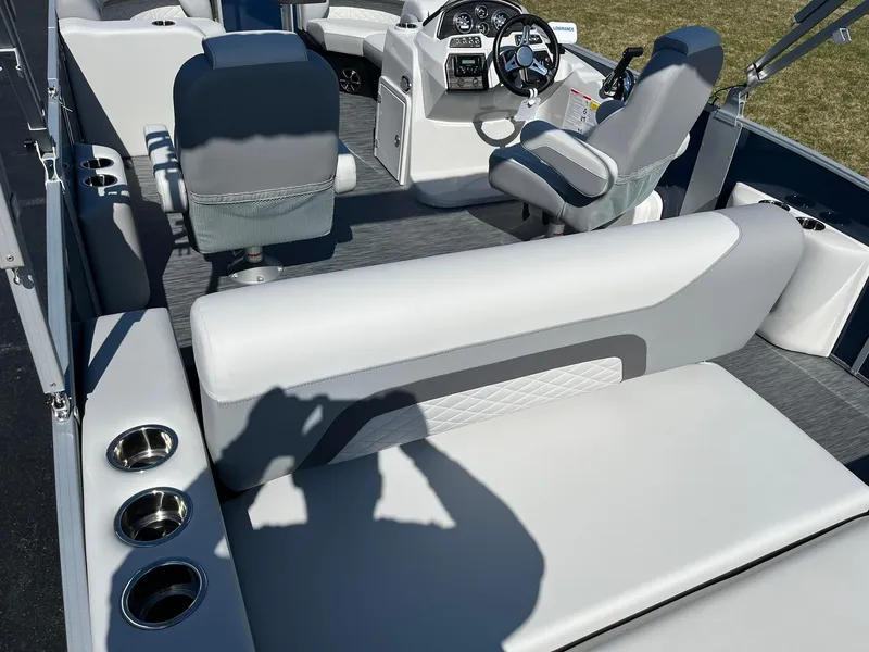 Slide: The Image of 2024 Lowe SS 210 DL boat interior with seating and steering console. - 18