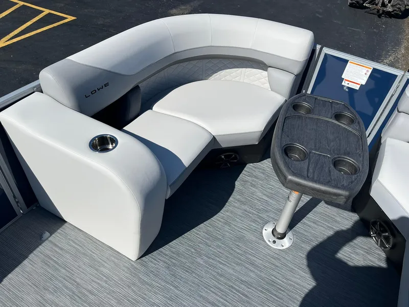 Slide: The Image of 2024 Lowe SS 210 DL boat interior with gray seating and cup holders. - 22