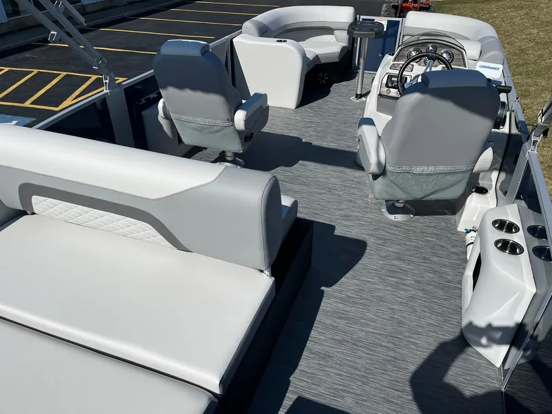 Slide: The Image of 2024 Lowe SS 210 DL pontoon boat interior with seating and steering console. - 24