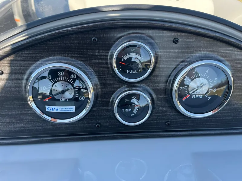 Slide: The Image of Dashboard of 2024 Lowe SS 210 DL boat with speedometer, fuel gauge, trim, and RPM indicators. - 26