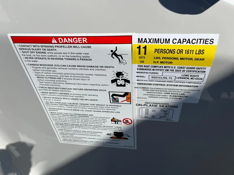 Slide: The Image of Warning and capacity labels on 2024 Lowe SS 210 DL boat, indicating maximum 11 persons or 1611 lbs. - 27