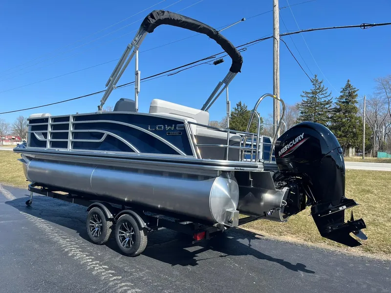 Slide: The Image of 2024 Lowe SS 210 DL pontoon boat with Mercury outboard motor on trailer. - 29