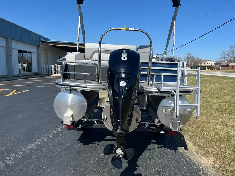 Slide: The Image of 2024 Lowe SS 210 DL pontoon boat rear view with outboard motor. - 4