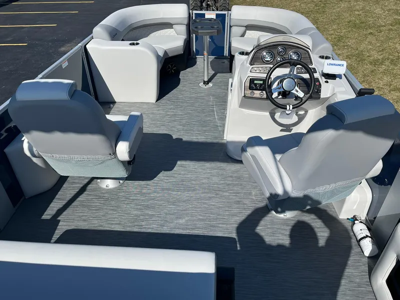 Slide: The Image of 2024 Lowe SS 210 DL pontoon boat interior with modern seating and steering console. - 6