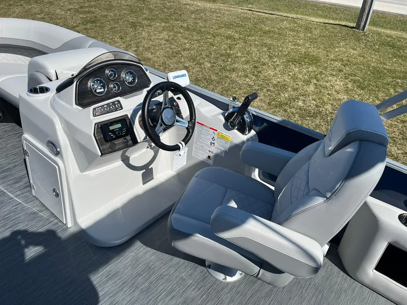 Slide: The Image of 2024 Lowe SS 210 DL boat cockpit with steering wheel and captain's chair. - 7