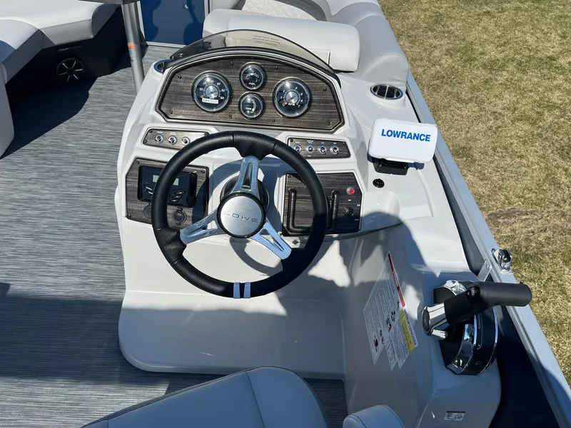 Slide: The Image of 2024 Lowe SS 210 DL boat dashboard with steering wheel and Lowrance navigation system. - 8