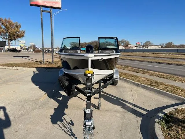 Slide: The Image of 2024 Lund 1875 Crossover XS boat on a trailer in a parking lot. - 1