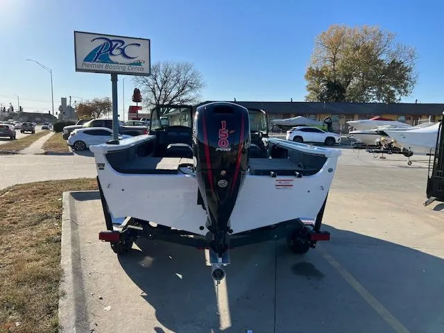Slide: The Image of 2024 Lund 1875 Crossover XS boat at Premier Boating Center parking lot. - 2