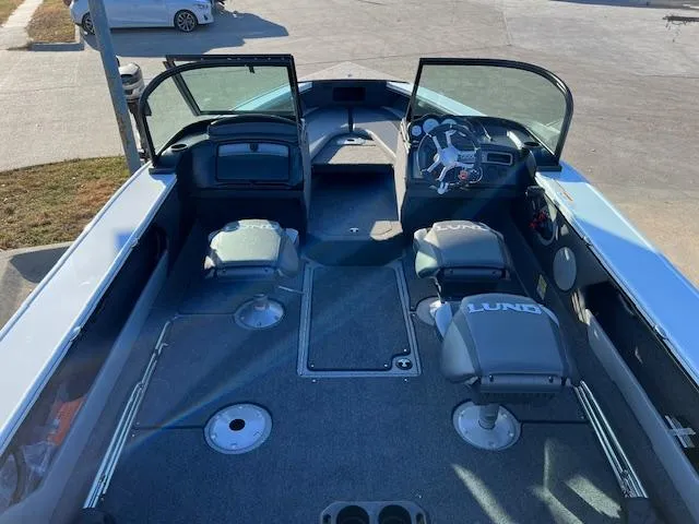 Slide: The Image of 2024 Lund 1875 Crossover XS boat interior with seating and steering console. - 4