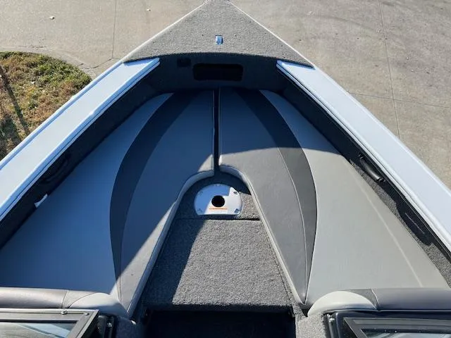 Slide: The Image of 2024 Lund 1875 Crossover XS boat interior, front seating area with gray upholstery. - 5