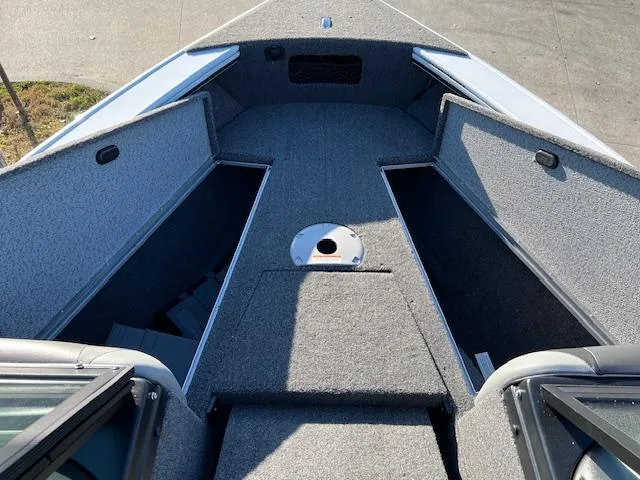 Slide: The Image of 2024 Lund 1875 Crossover XS boat interior with open storage compartments. - 6