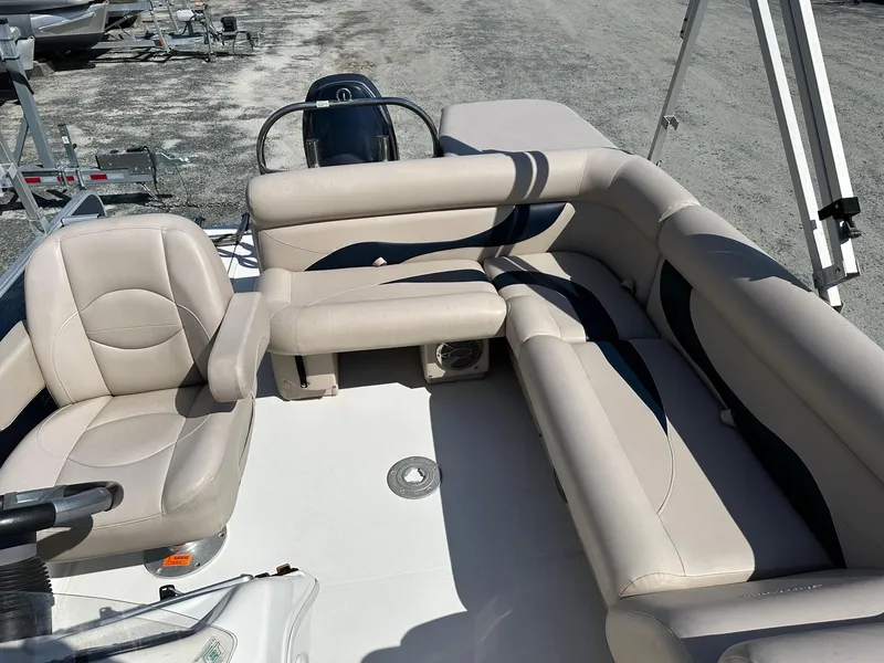 Slide: The Image of 2014 Godfrey Hurricane boat with beige seating and steering console. - 11