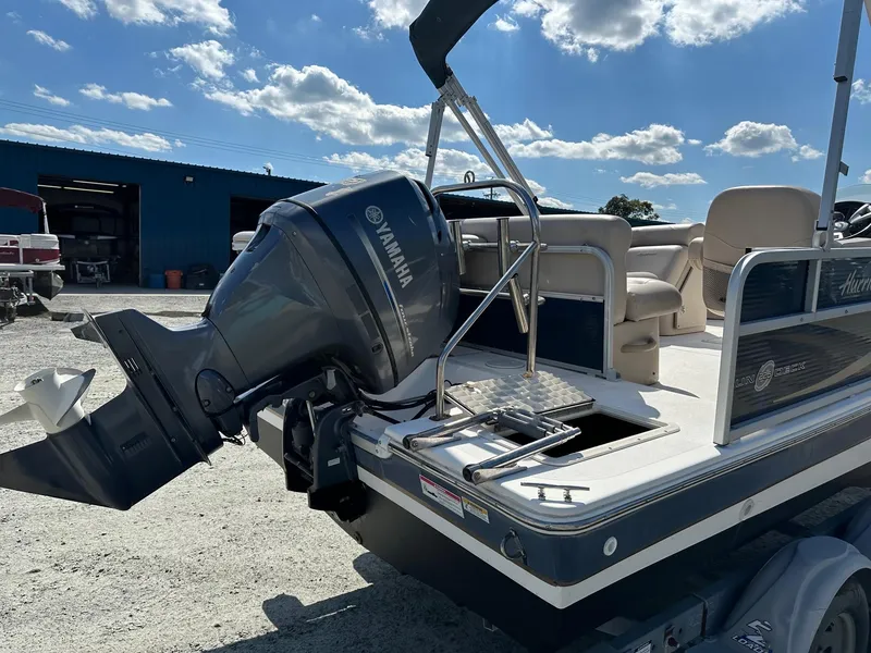 Slide: The Image of 2014 Godfrey Hurricane boat with Yamaha outboard motor in a sunny outdoor setting. - 12