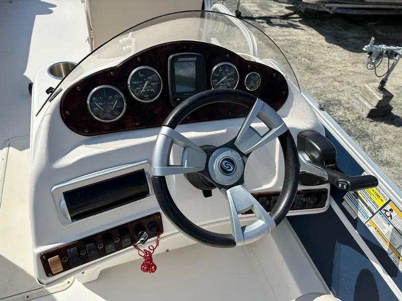 Slide: The Image of 2014 Godfrey Hurricane boat dashboard with steering wheel and instrument panel. - 5