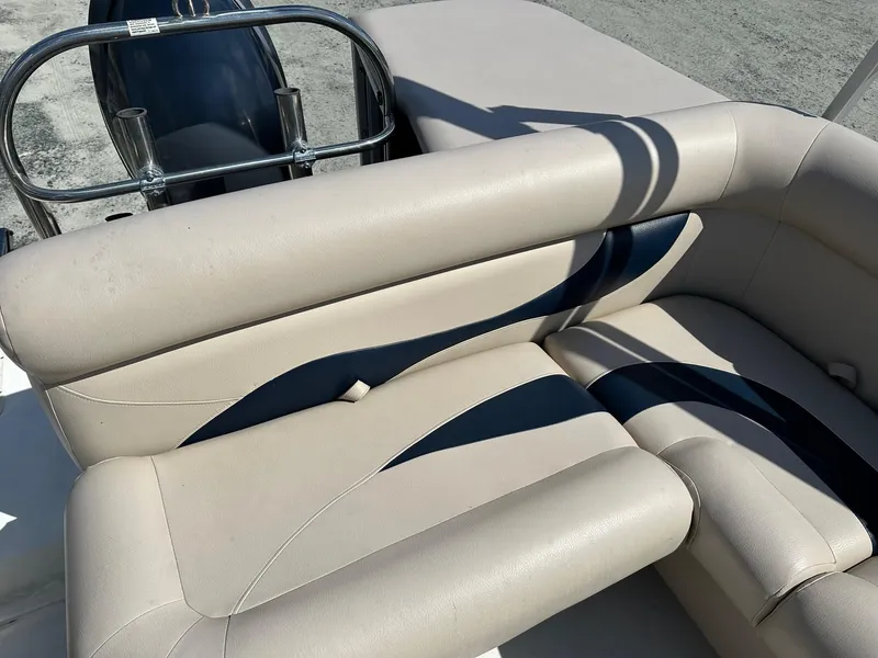 Slide: The Image of 2014 Godfrey Hurricane boat with beige and black cushioned seating. - 6