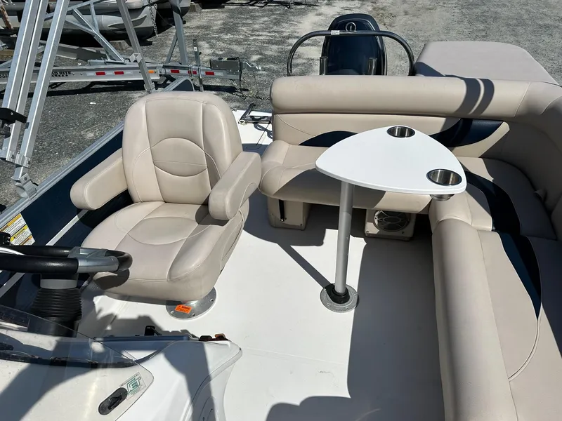 Slide: The Image of 2014 Godfrey Hurricane boat interior with seating and table. - 9
