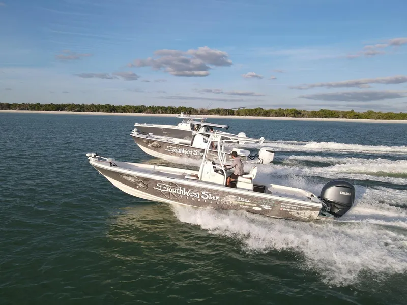 Slide: The Image of 2014 Pathfinder 2600 HPS boats cruising on open water under a clear sky. - 0