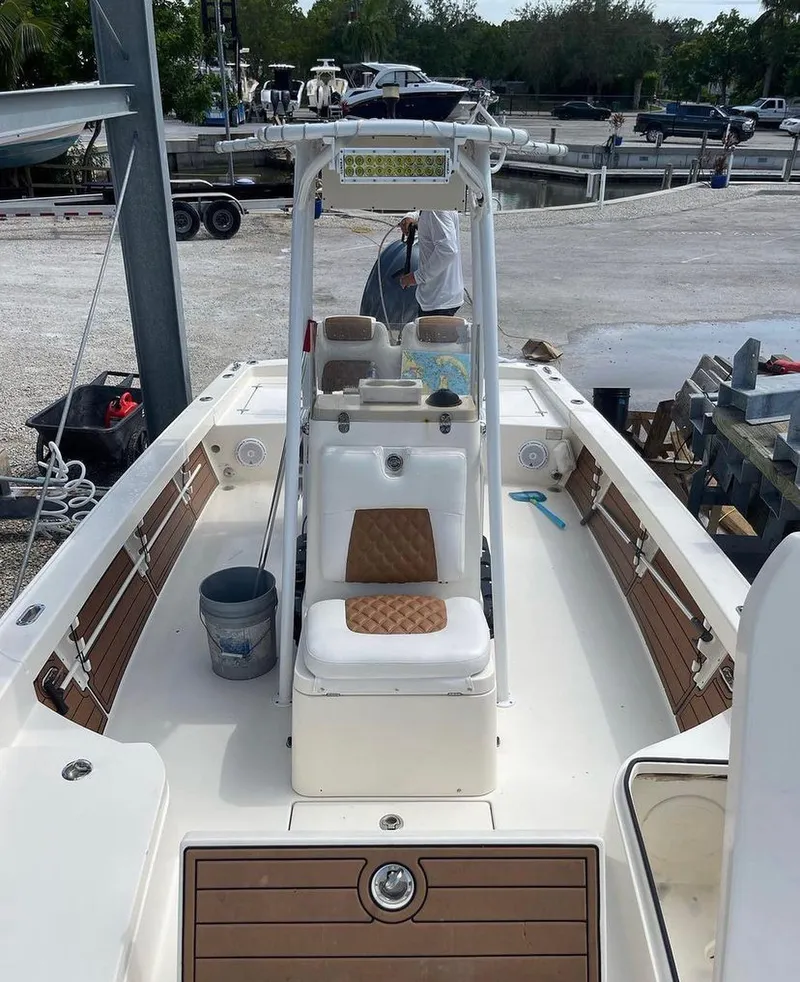 Slide: The Image of 2014 Pathfinder 2600 HPS boat docked, interior view with seating and fishing gear. - 14