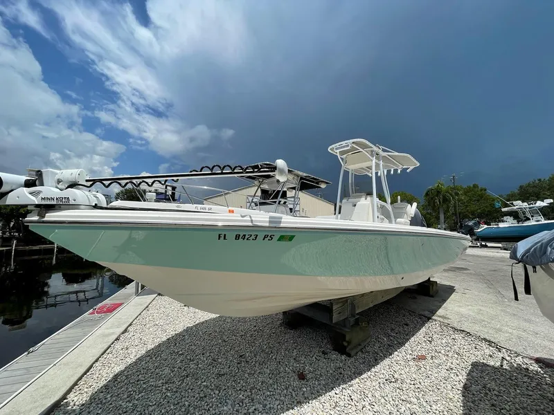 Slide: The Image of 2014 Pathfinder 2600 HPS boat docked on gravel near water. - 17