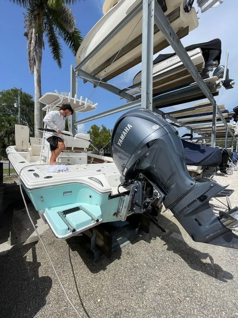 Slide: The Image of 2014 Pathfinder 2600 HPS boat with Yamaha outboard motor in storage. - 19