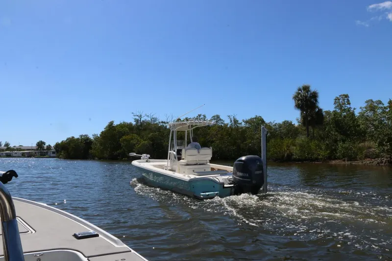 Slide: The Image of 2014 Pathfinder 2600 HPS boat cruising on a river with lush greenery. - 21