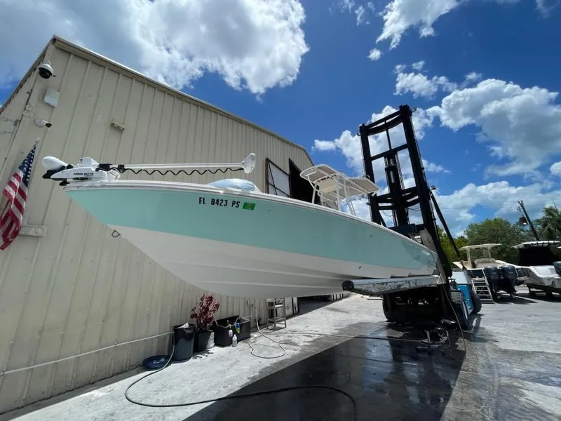 Slide: The Image of 2014 Pathfinder 2600 HPS boat on a lift under a blue sky. - 23