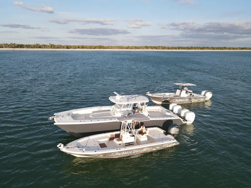 Slide: The Image of Two Pathfinder boats, including a 2014 2600 HPS, floating on calm water. - 3