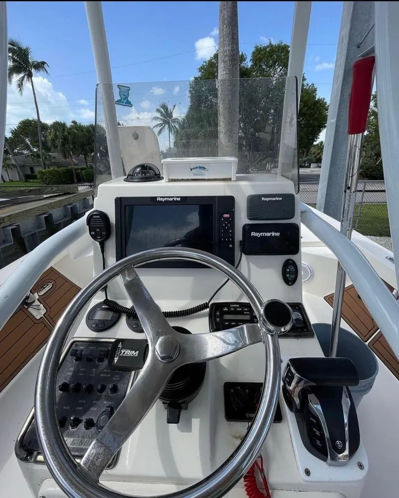 Slide: The Image of 2014 Pathfinder 2600 HPS boat console with steering wheel and navigation equipment. - 7