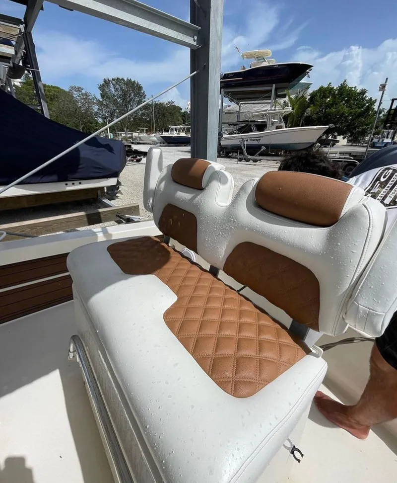 Slide: The Image of 2014 Pathfinder 2600 HPS boat with cushioned seating at a marina. - 8