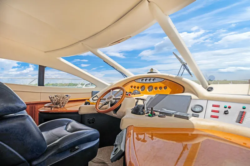 Slide: The Image of 2004 Azimut 62 yacht cockpit with modern controls and leather seating. - 11