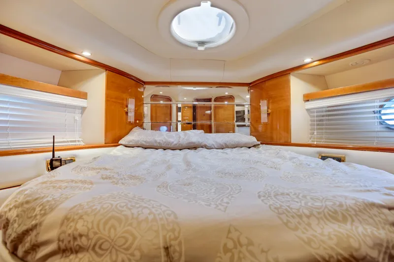 Slide: The Image of Luxurious bedroom interior of 2004 Azimut 62 yacht with elegant bedding and wood accents. - 17
