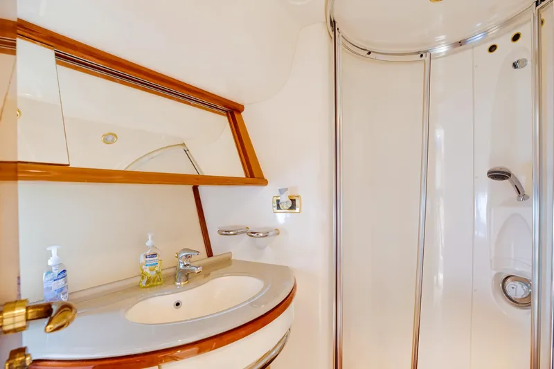 Slide: The Image of Luxurious bathroom in a 2004 Azimut 62 yacht with sink and shower. - 19