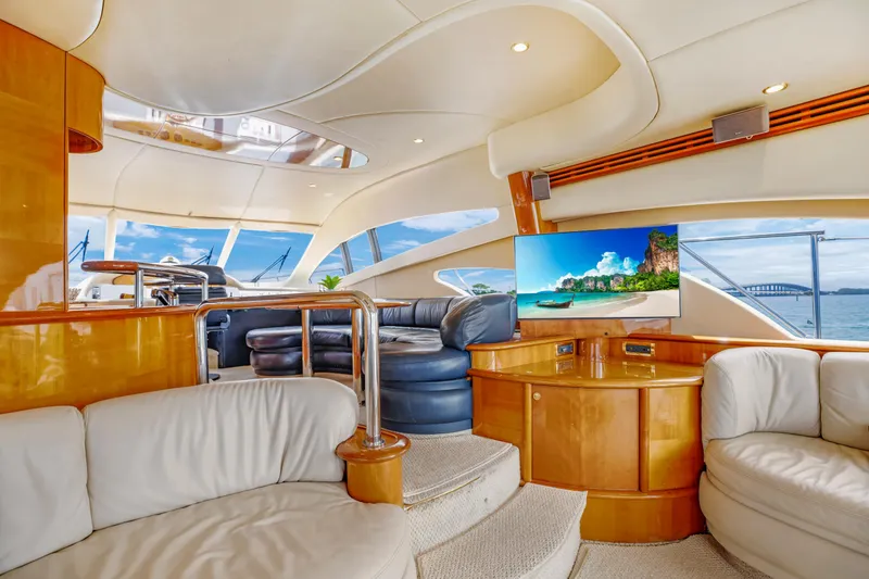 Slide: The Image of Luxurious interior of a 2004 Azimut 62 yacht with plush seating and a flat-screen TV. - 7