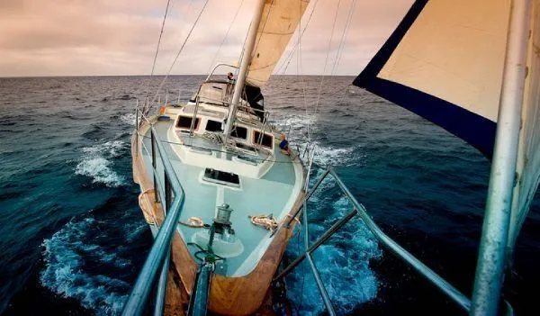 Slide: The Image of 1984 Irwin Center Cockpit sailboat navigating open sea under cloudy skies. - 1