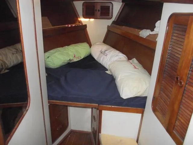 Slide: The Image of 1984 Irwin Center Cockpit cabin interior with bed and pillows. - 12