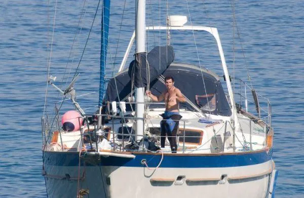 Slide: The Image of 1984 Irwin Center Cockpit sailboat with person on deck, sailing on calm blue waters. - 2