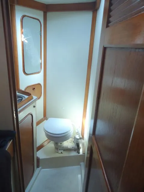 Slide: The Image of 1984 Irwin Center Cockpit bathroom with wooden accents and compact design. - 32