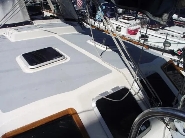Slide: The Image of 1984 Irwin Center Cockpit sailboat deck with hatches and rigging, docked in a marina. - 7