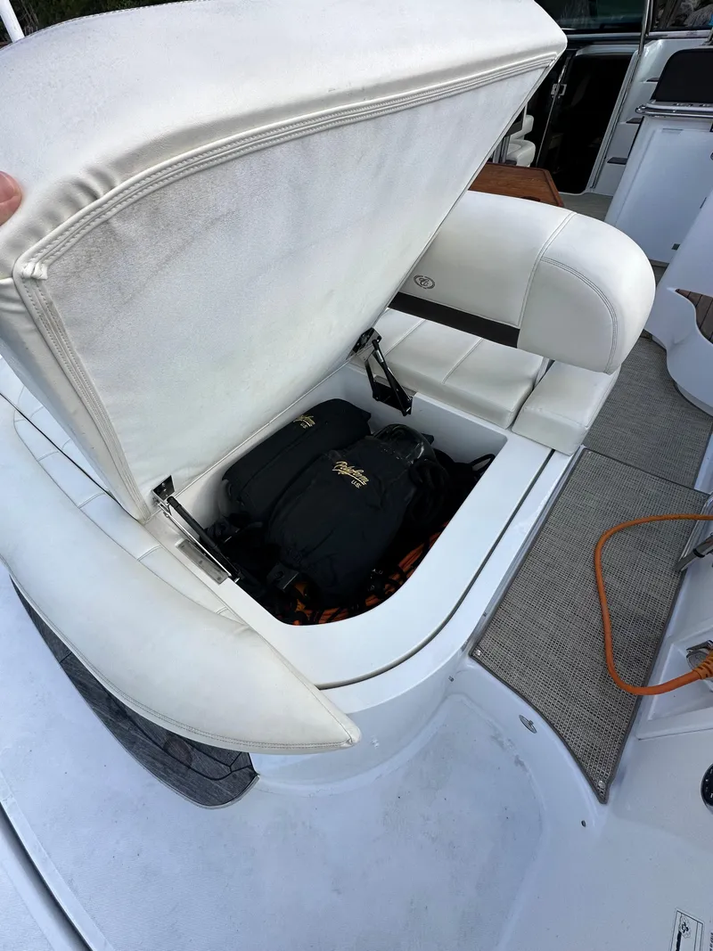 Slide: The Image of 2015 Cobalt A40 boat with open storage compartment and bags inside. - 22