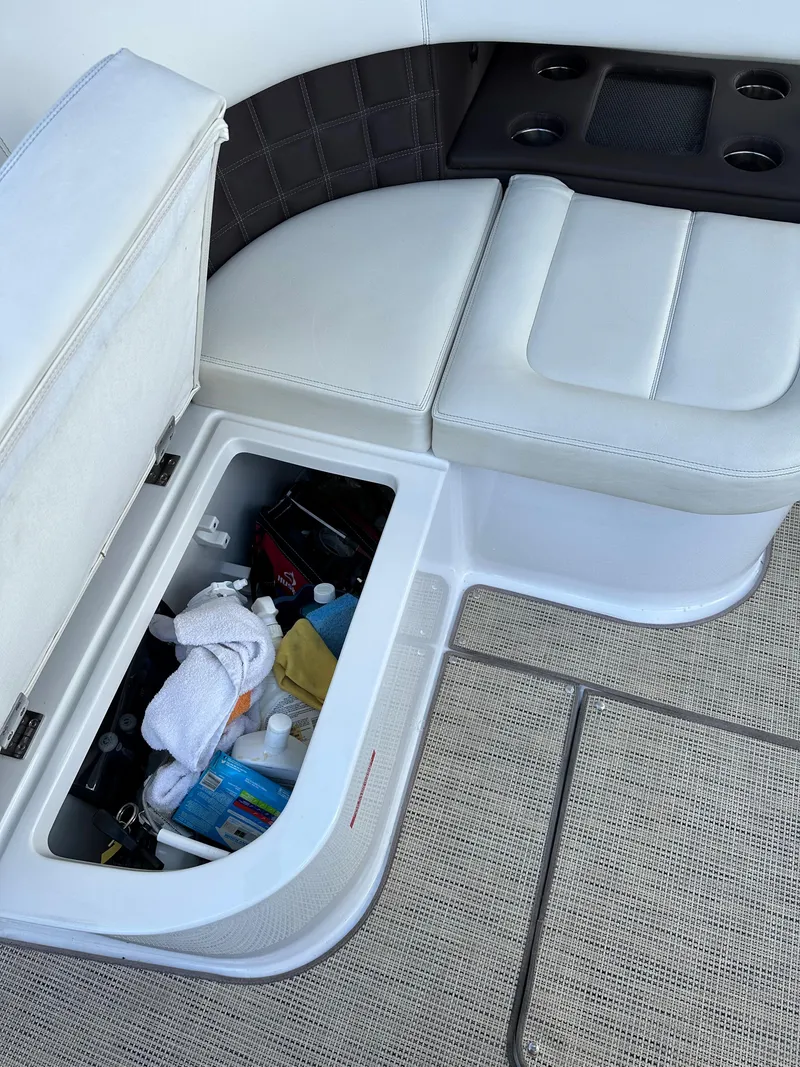 Slide: The Image of Storage compartment on a 2015 Cobalt A40 boat with white cushioned seating. - 26
